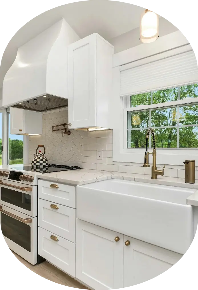 Timberline Build Co - Formerly Contractor Orange County | General Contractor in Orange County 4 Bright white kitchen with farmhouse sink, gold faucet, and herringbone backsplash. Timberline Build Co.
