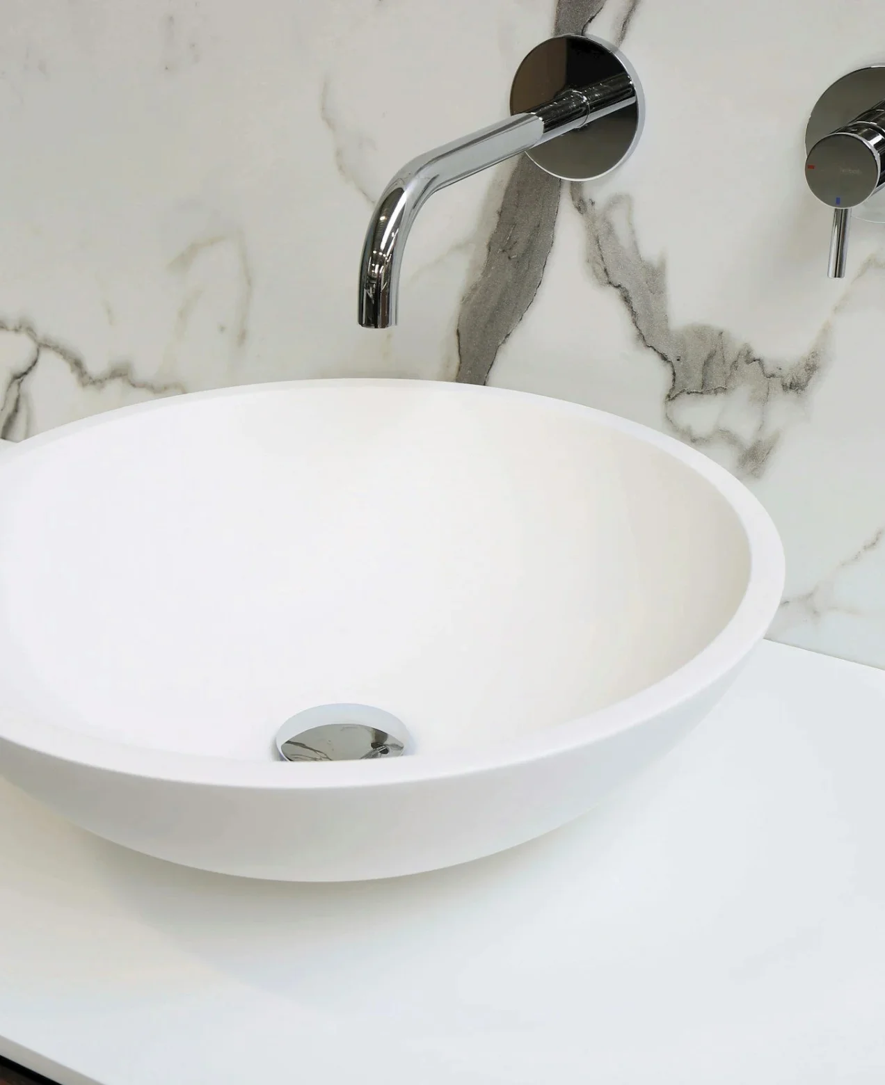 Bathroom Remodeling in Rancho Santa Margarita | Contractor Orange County — Timberline Build Co 1 Modern bathroom sink with chrome faucet and marble backsplash. Bathroom remodeling in Rancho Santa Margarita.