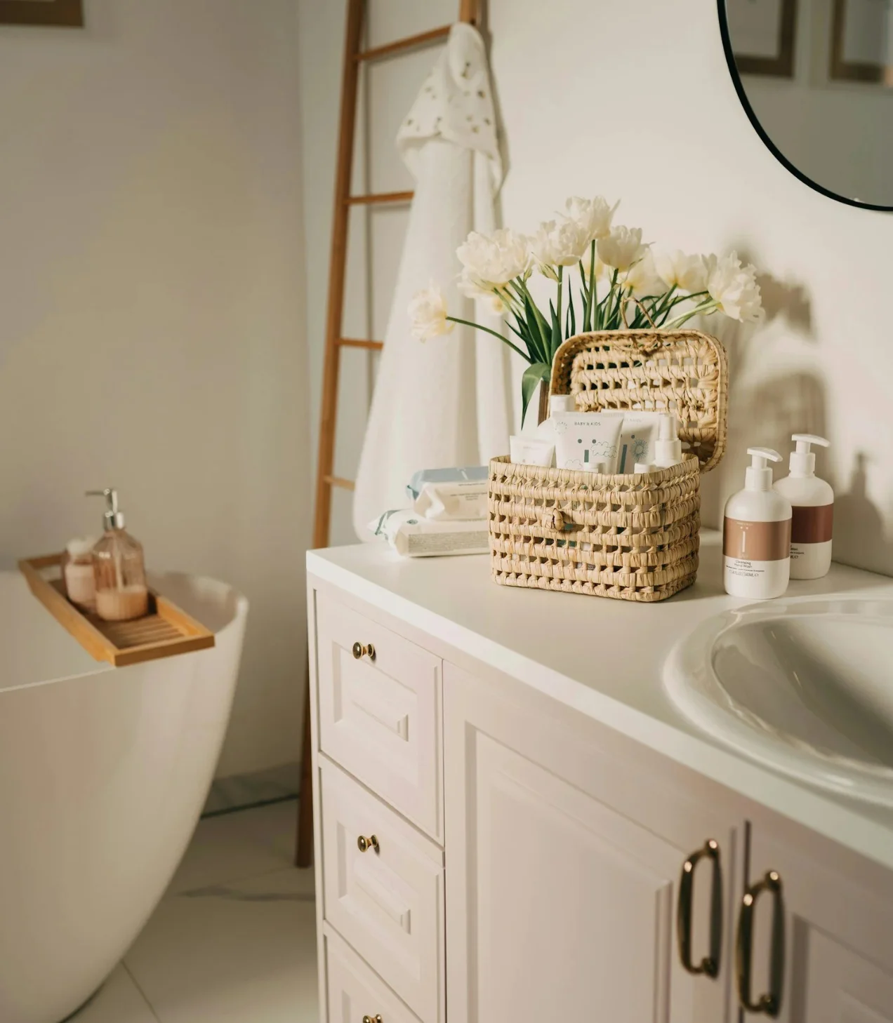 Bathroom remodel in Ladera Ranch: White vanity with flowers, towels, and bath