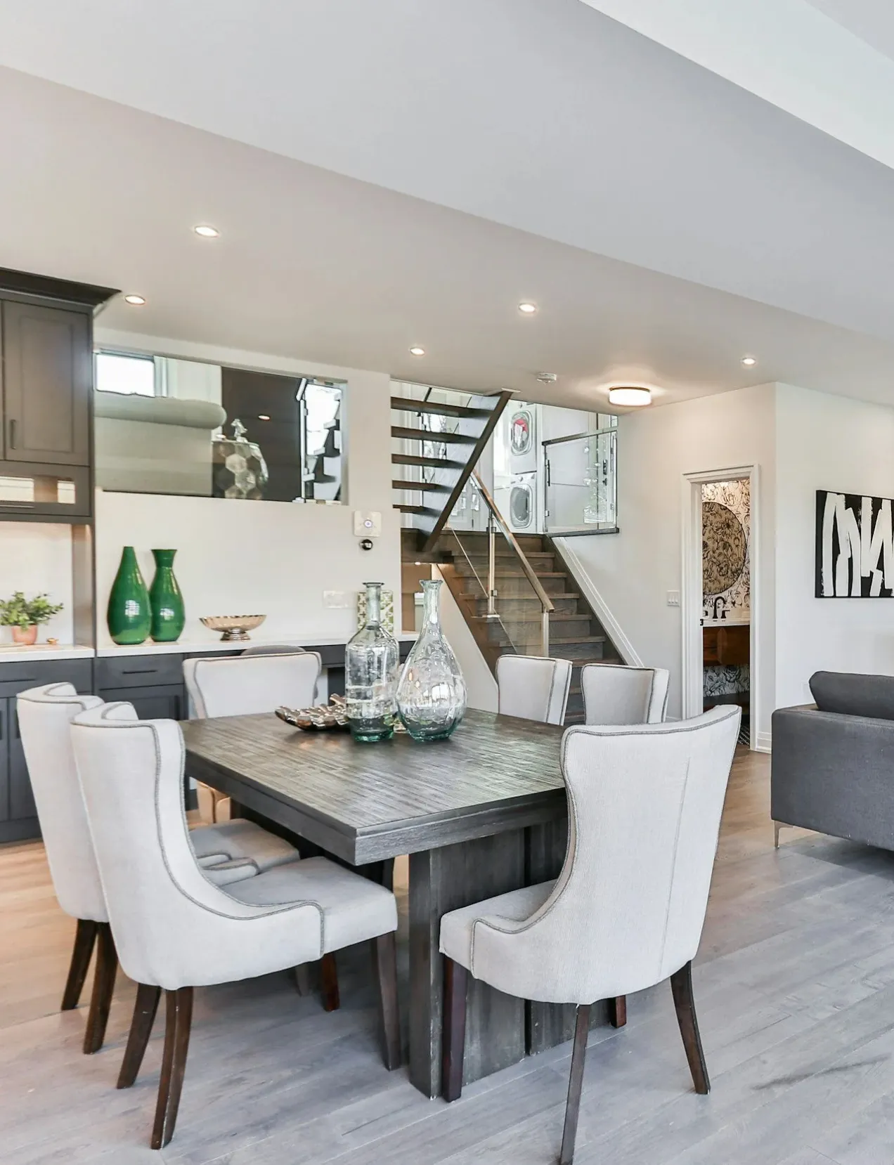 Modern dining area with gray table and chairs, part of a San Clemente kitchen remodel.