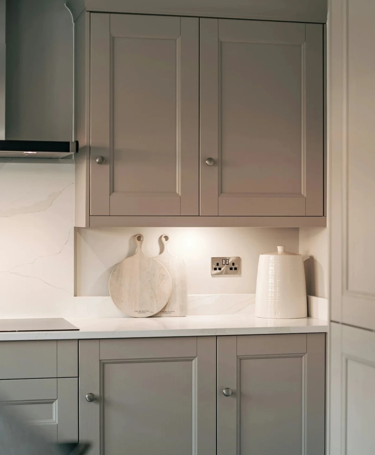 Gray kitchen cabinets with white countertops and decor, showcasing kitchen remodeling in Mission Viejo.