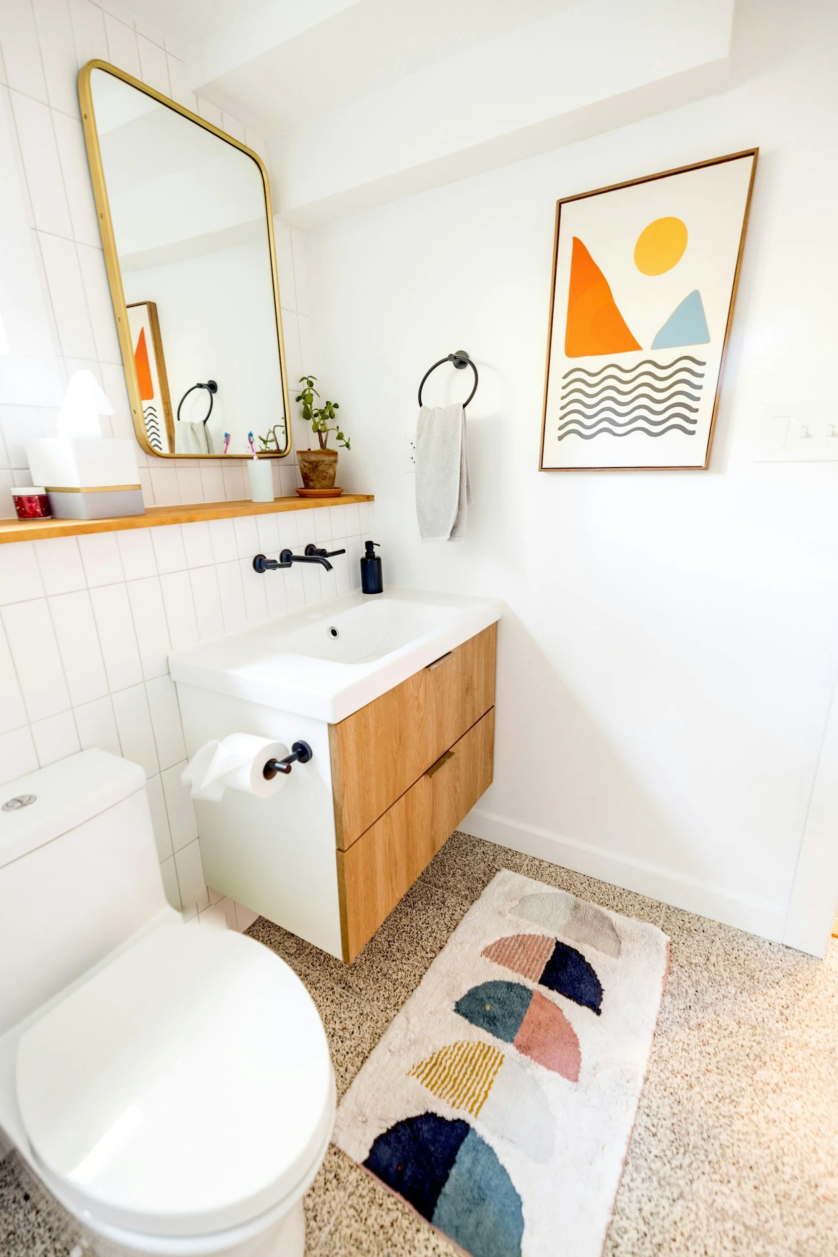 Bathroom Remodeling Aliso Viejo | Contractor Orange County — Timberline Build Co 1 Modern bathroom remodel in Aliso Viejo with floating vanity, terrazzo floor, and abstract art.