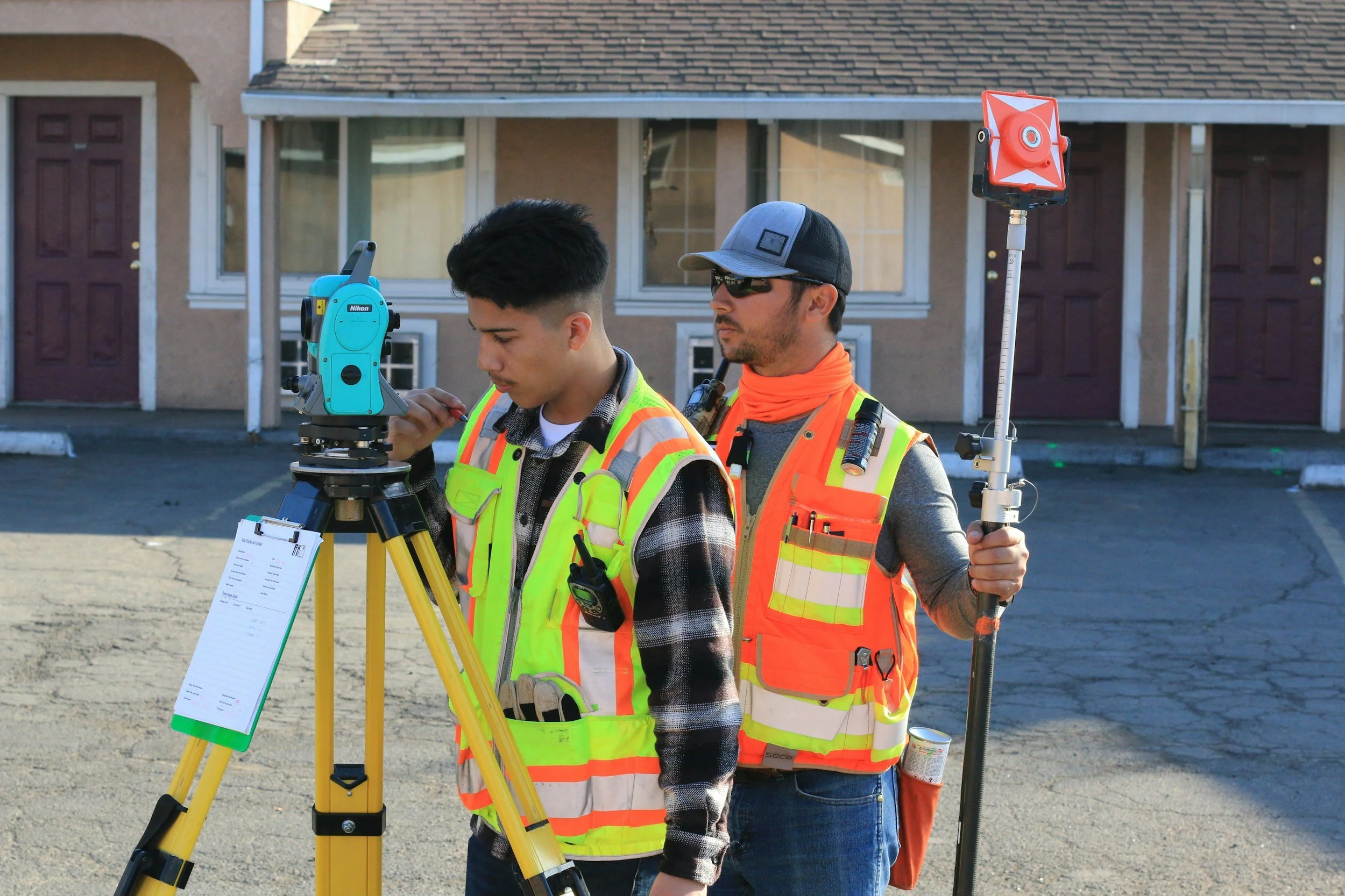 Comprehensive Guide to General Contracting: Local Services, Costs, & Hiring Tips 4 Surveyors using surveying equipment on a construction site.
