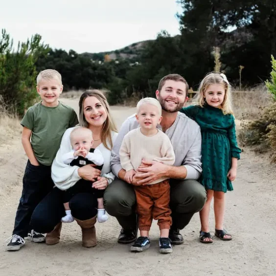 Family portrait in nature setting. Happy family of seven outdoors.