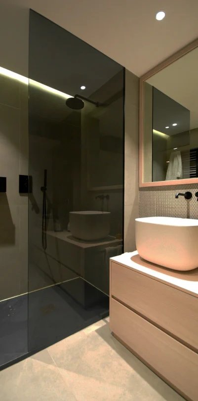 Modern bathroom remodel with a glass shower, vessel sink, and light wood vanity. Part of a Rancho Santa Margarita project.